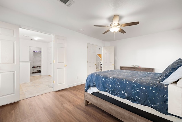 bedroom with ceiling fan and light hardwood / wood-style floors