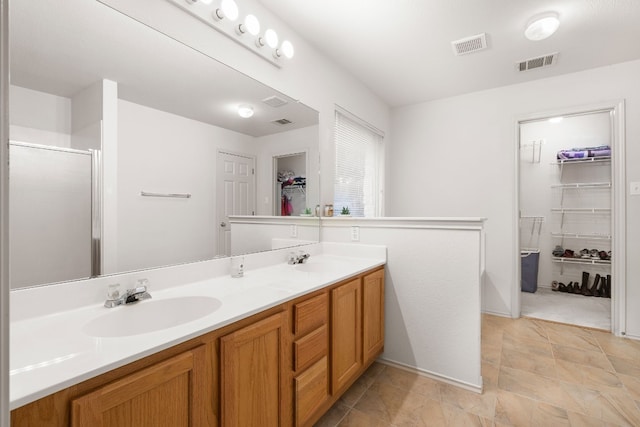 bathroom with vanity and a shower with door