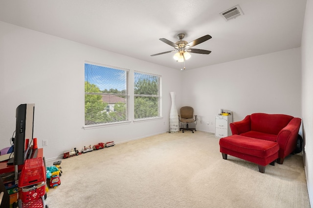 sitting room with carpet flooring and ceiling fan