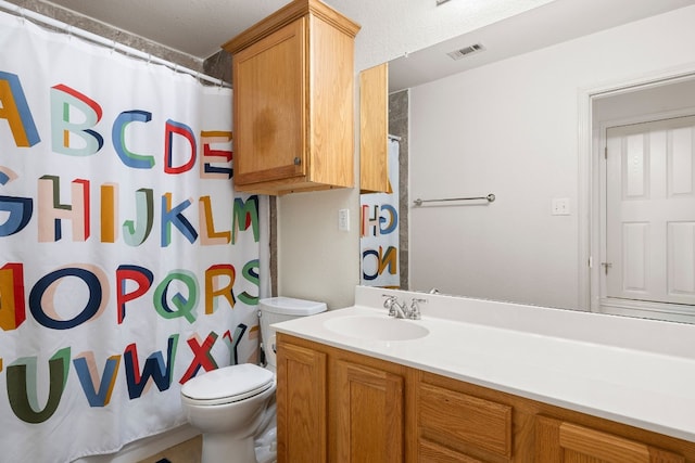 bathroom featuring vanity, curtained shower, and toilet