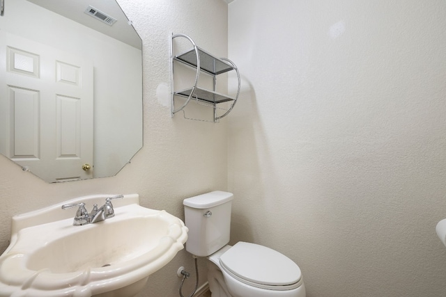 bathroom featuring sink and toilet