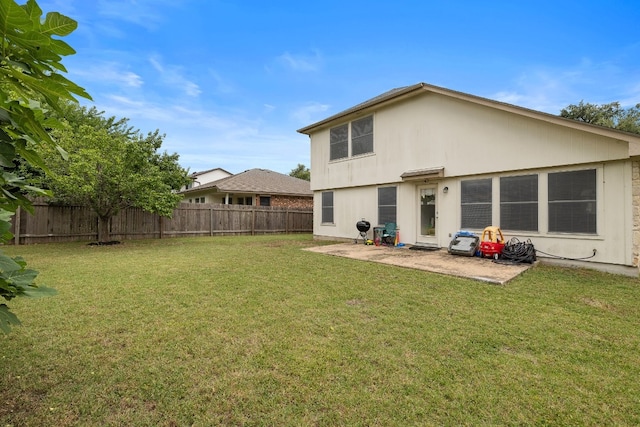 back of property featuring a yard