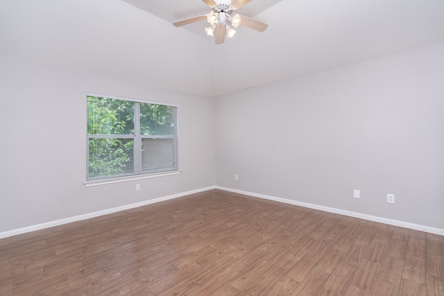 spare room featuring wood-type flooring, ceiling fan, and lofted ceiling