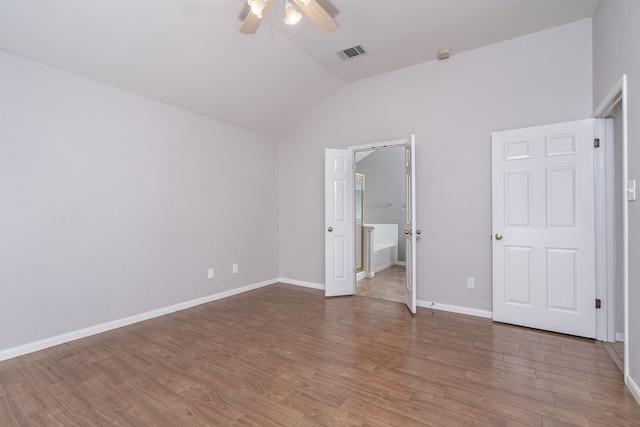 unfurnished bedroom with hardwood / wood-style flooring, ceiling fan, and lofted ceiling