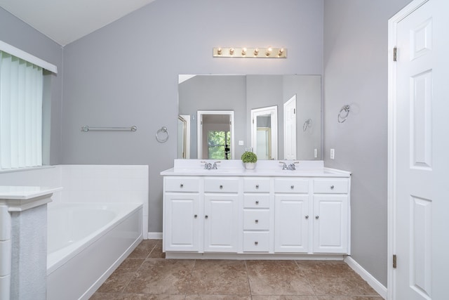 bathroom featuring shower with separate bathtub, vanity, and vaulted ceiling