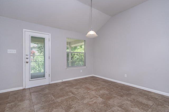 unfurnished room with lofted ceiling and a wealth of natural light