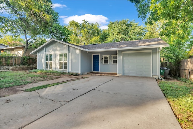 ranch-style home featuring a garage