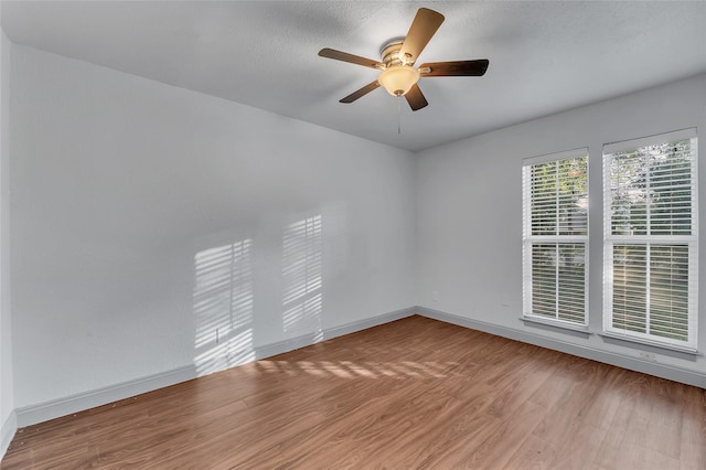 spare room with ceiling fan and wood-type flooring