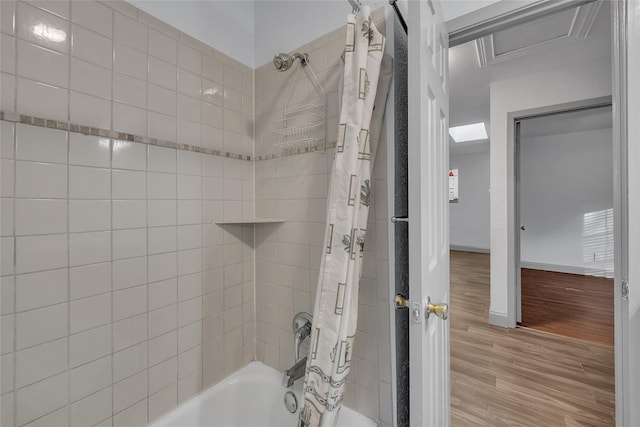 bathroom with shower / bathtub combination with curtain and hardwood / wood-style floors