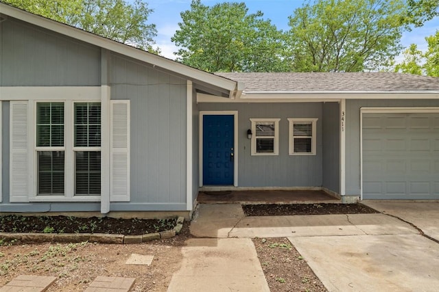 3411 Thomas Kincheon St, Austin, TX 78745 - doorway to property with an attached garage, concrete driveway, and roof with shingles