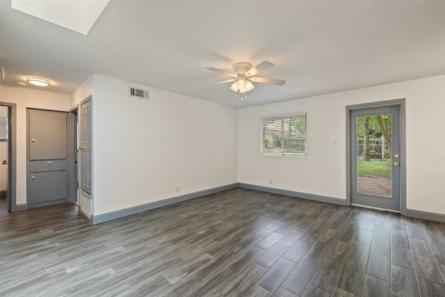 3411 Thomas Kincheon St, Austin, TX 78745 - spare room featuring wood finished floors, a skylight, and a ceiling fan