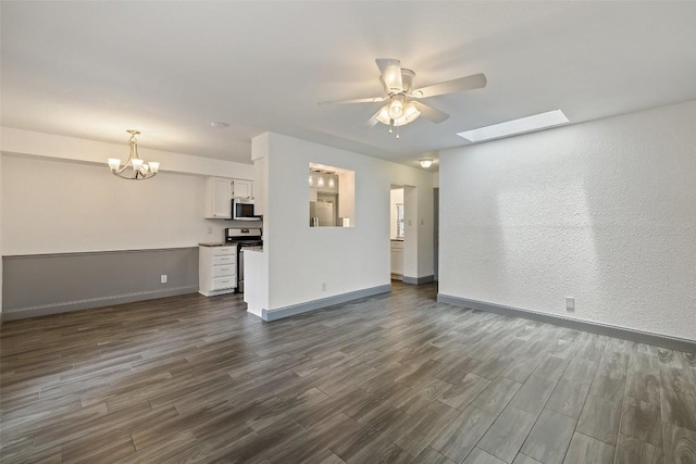 3411 Thomas Kincheon St, Austin, TX 78745 - unfurnished living room with ceiling fan, dark wood-style flooring, a chandelier, and a skylight
