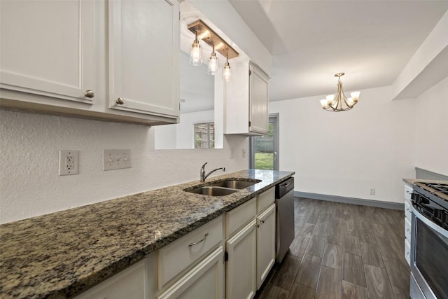 3411 Thomas Kincheon St, Austin, TX 78745 - kitchen featuring appliances with stainless steel finishes, a chandelier, dark stone counters, hanging light fixtures, and dark wood-type flooring
