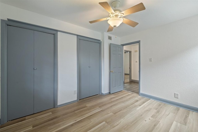 3411 Thomas Kincheon St, Austin, TX 78745 - unfurnished bedroom featuring light wood finished floors, ceiling fan, and multiple closets