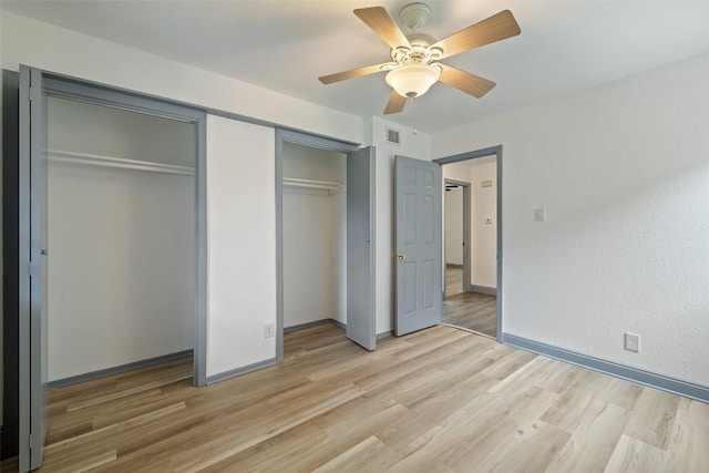 3411 Thomas Kincheon St, Austin, TX 78745 - unfurnished bedroom with multiple closets, light wood-style floors, and ceiling fan