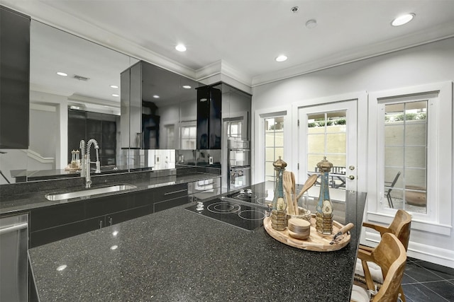 kitchen with ornamental molding, sink, black electric cooktop, dishwasher, and dark stone counters