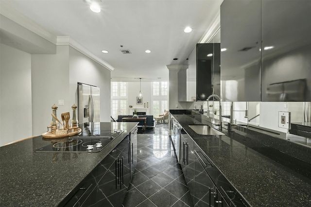 kitchen featuring sink, hanging light fixtures, black electric cooktop, ornamental molding, and dark stone countertops