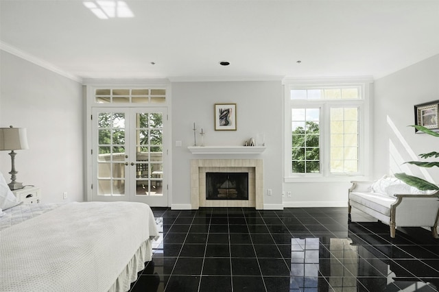 tiled bedroom featuring a tile fireplace, ornamental molding, and french doors