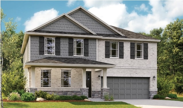 craftsman inspired home featuring a garage and a front lawn