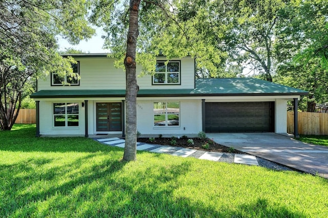 view of front of property with a garage, french doors, fence, and a front lawn