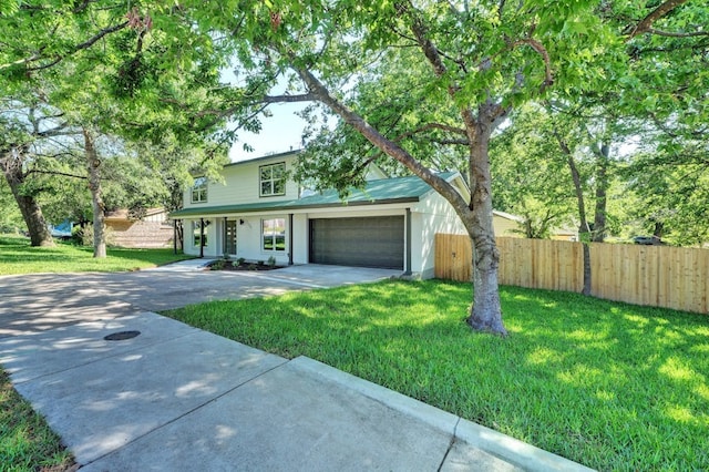 view of front of property featuring a garage and a front lawn