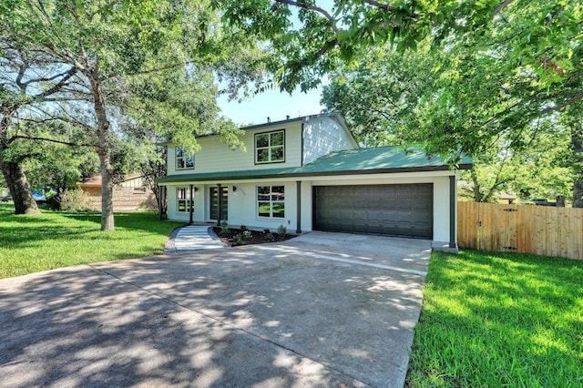 view of front of house with a garage and a front lawn