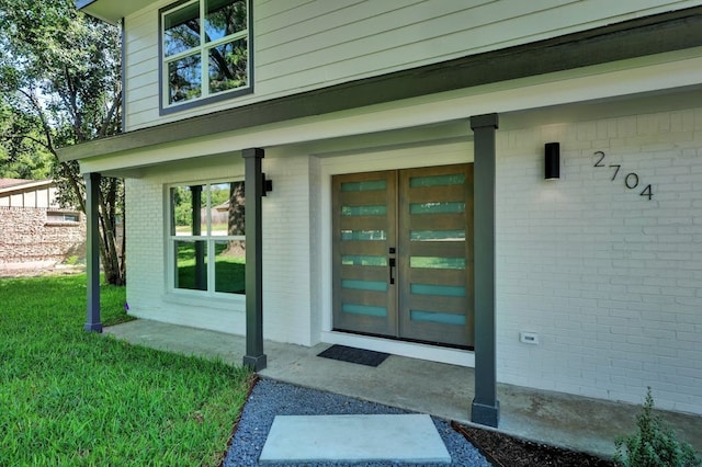 view of exterior entry with a porch