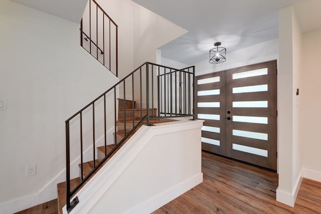 entrance foyer with french doors and hardwood / wood-style floors