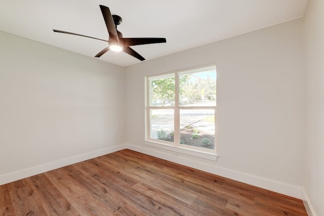 spare room with wood-type flooring and ceiling fan