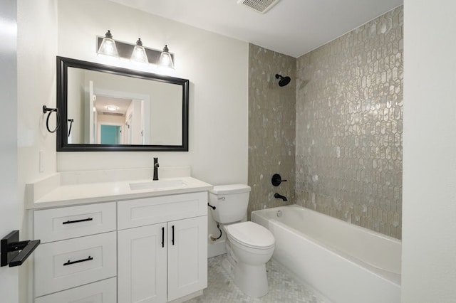 full bathroom with tiled shower / bath combo, tile patterned floors, toilet, and vanity