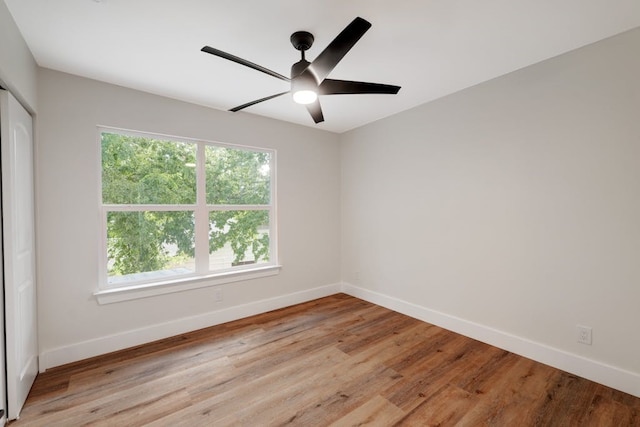 empty room featuring ceiling fan and light hardwood / wood-style flooring