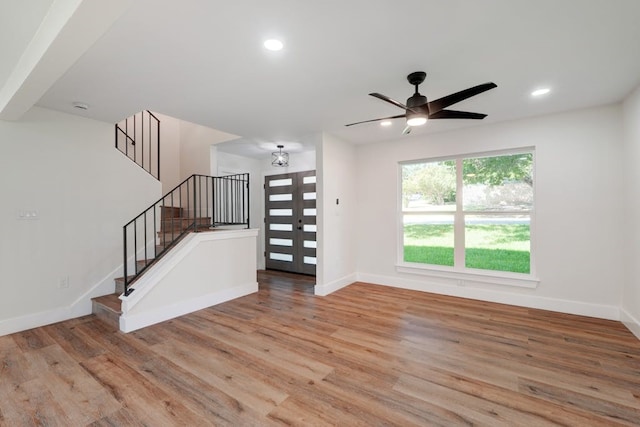 unfurnished living room with light hardwood / wood-style flooring and ceiling fan