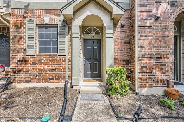 entrance to property with brick siding