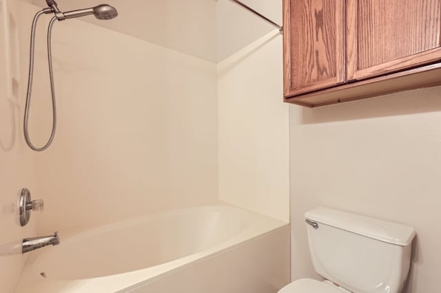 bathroom with shower / washtub combination and toilet