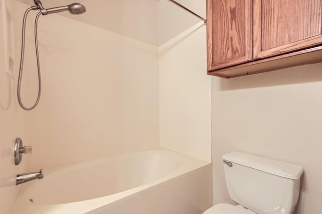 bathroom with shower / bathing tub combination and toilet