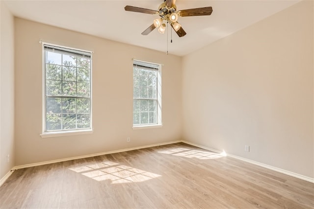 unfurnished room with baseboards, light wood-style flooring, and ceiling fan