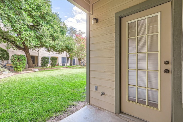property entrance with a yard