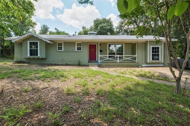 ranch-style home with covered porch and brick siding