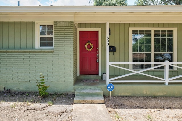 property entrance featuring brick siding