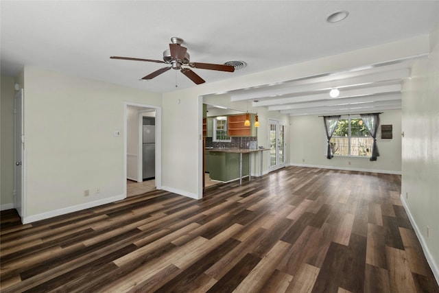 unfurnished living room featuring dark wood-style floors, beam ceiling, visible vents, a ceiling fan, and baseboards