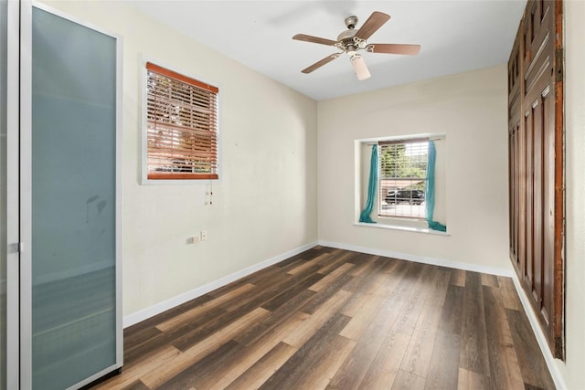 unfurnished bedroom featuring dark wood-style floors, ceiling fan, and baseboards