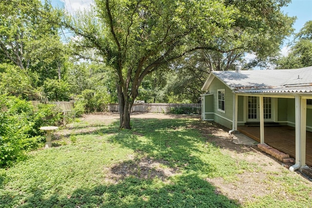 view of yard with french doors and a fenced backyard