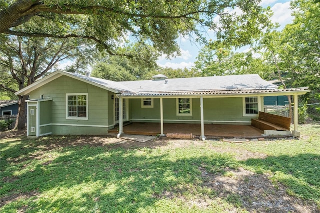 back of house with a yard and fence