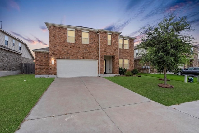 view of front of home featuring a garage and a lawn