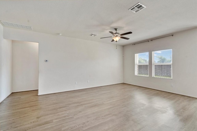 unfurnished room featuring a textured ceiling, light hardwood / wood-style floors, and ceiling fan