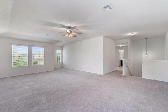 spare room with ceiling fan, light colored carpet, and a textured ceiling