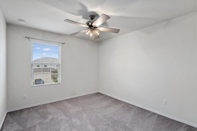 empty room featuring carpet flooring and ceiling fan