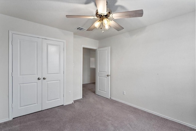 unfurnished bedroom featuring carpet flooring, ceiling fan, and a closet