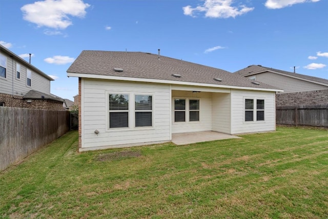 rear view of house with a lawn and a patio area