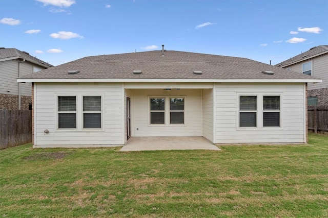 back of house featuring a lawn and a patio